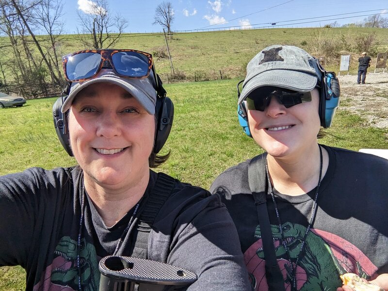 Karen Farthing and Courtney McCarthy Beadnell at an outdoor range, wearing ear protection